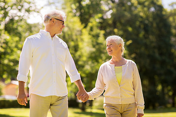 Image showing happy senior couple walking at summer park