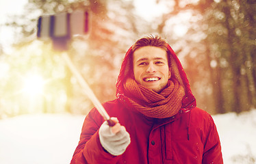 Image showing happy man taking selfie by smartphone in winter