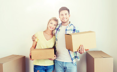 Image showing smiling couple with big boxes moving to new home