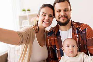 Image showing mother and father with baby taking selfie at home