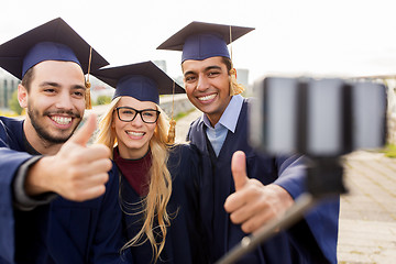 Image showing students or graduates taking selfie by smartphone