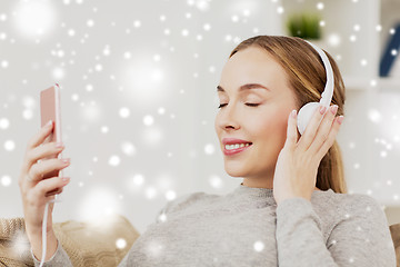 Image showing woman with smartphone and headphones at home