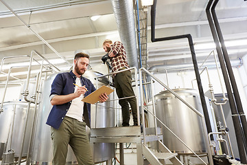 Image showing men with clipboard at brewery or beer plant