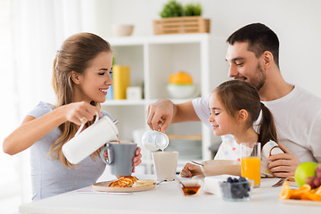 Image showing happy family having breakfast at home