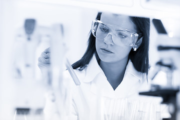 Image showing Female chemist working in scientific laboratory.