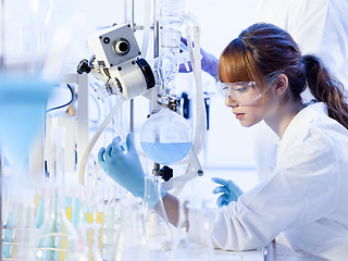 Image showing Young female chemists researching in life science laboratory.