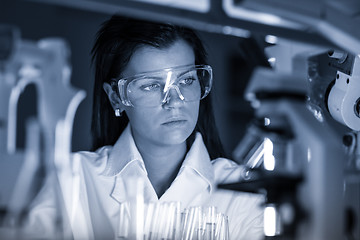 Image showing Female chemist working in scientific laboratory.