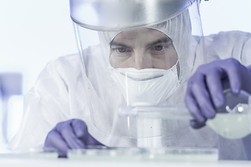 Image showing Life scientist researching in bio hazard laboratory. High degree of protection work.