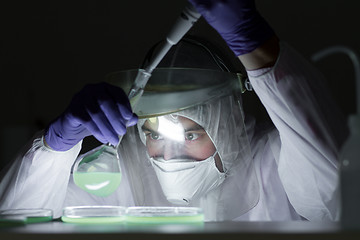 Image showing Life scientist researching in bio hazard laboratory. High degree of protection work.