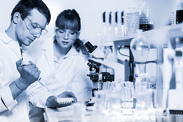Image showing Health care professionals microscoping in scientific laboratory.