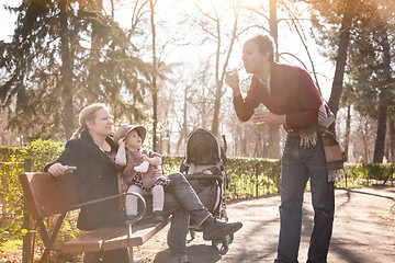 Image showing Young family with cheerful child in the park.