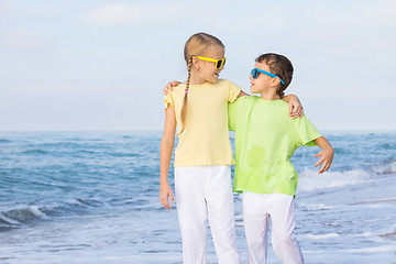 Image showing Two happy children playing on the beach at the day time