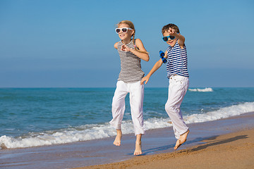 Image showing Two happy children playing on the beach at the day time