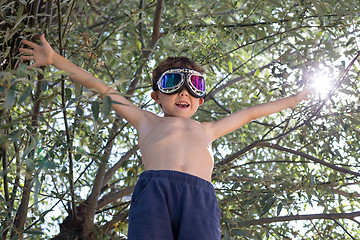 Image showing Happy little boy playing outdoors.