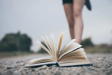 Image showing open book lying on the road.