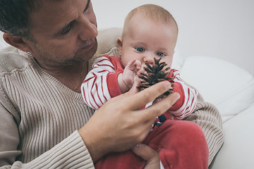 Image showing Happy  father having fun with newborn baby son, family portrait 