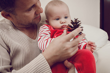 Image showing Happy  father having fun with newborn baby son, family portrait 