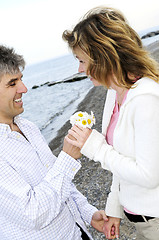 Image showing Mature romantic couple with flowers