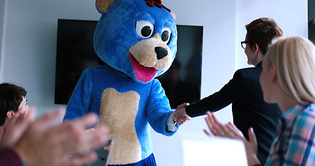 Image showing boss dresed as bear having fun with business people in trendy of