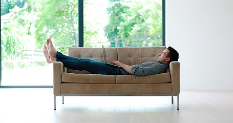 Image showing Man using laptop in living room