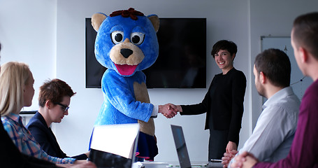 Image showing boss dresed as bear having fun with business people in trendy of