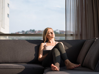 Image showing Woman Using Tablet On Couch At Home