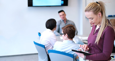 Image showing Pretty Businesswoman Using Tablet In Office Building during conf