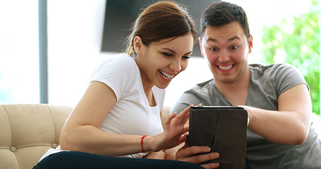 Image showing Young Couple using digital tablet at home