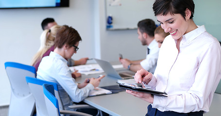 Image showing Portrait of  smiling casual businesswoman using tablet  with cow