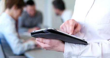 Image showing Businessman using tablet in modern office