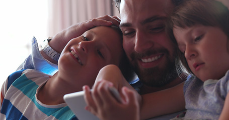 Image showing father and two kids having fun together at home