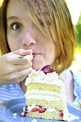 Image showing Girl eating a cake