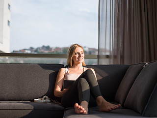 Image showing Woman Using Tablet On Couch At Home