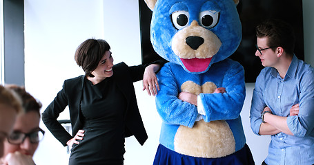 Image showing boss dresed as bear having fun with business people in trendy of