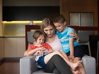 Image showing Young Family Using A Tablet To Make Future Plans