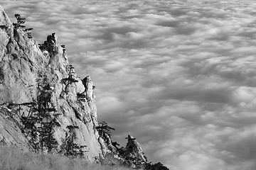 Image showing Black and white view of sunlit cliffs and sea in clouds