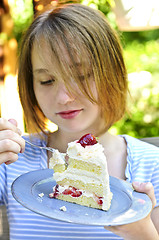 Image showing Girl eating a cake