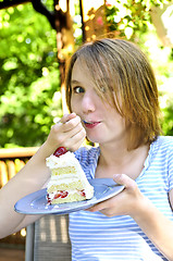 Image showing Girl eating a cake