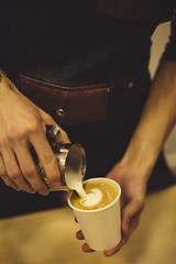 Image showing Bartender pouring coffee to cup