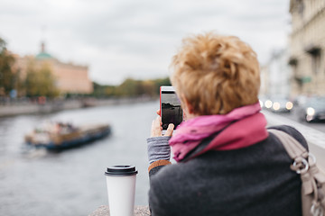 Image showing Woman taking shots from waterfront