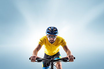 Image showing The bicyclist on gray, studio shot.