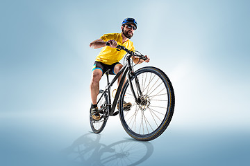 Image showing The bicyclist on gray, studio shot.