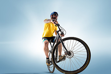 Image showing The bicyclist on gray, studio shot.