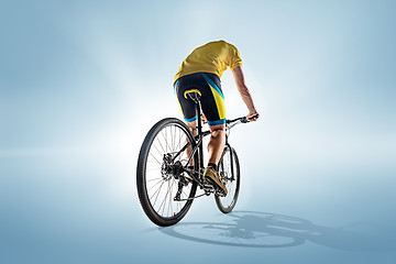 Image showing The bicyclist on gray, studio shot.