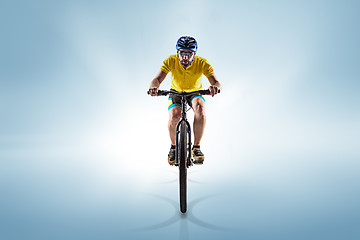 Image showing The bicyclist on gray, studio shot.