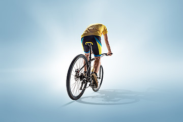 Image showing The bicyclist on gray, studio shot.