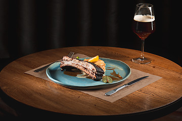 Image showing grilled pork ribs on dark plate