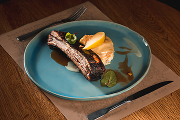 Image showing grilled pork ribs on dark plate