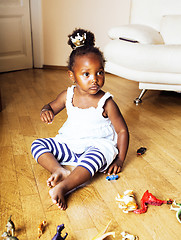 Image showing little cute african american girl playing with animal toys at ho