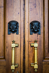 Image showing Sphinx heads entrance on wooden door